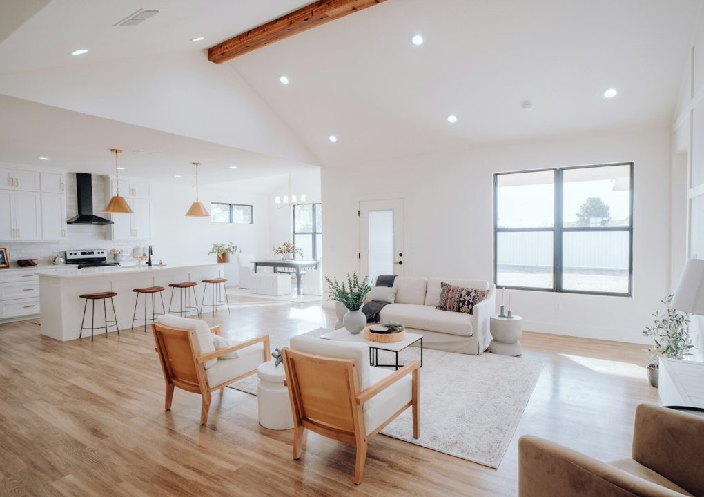 a living room filled with furniture and a kitchen